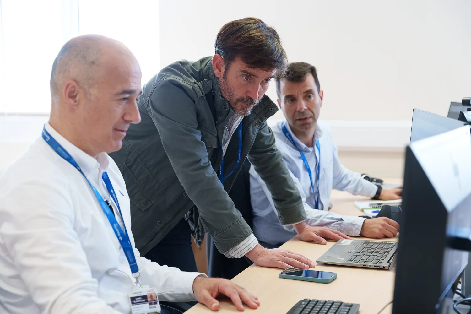 Navantia staff collaborating in a workspace, focused on their work and teamwork