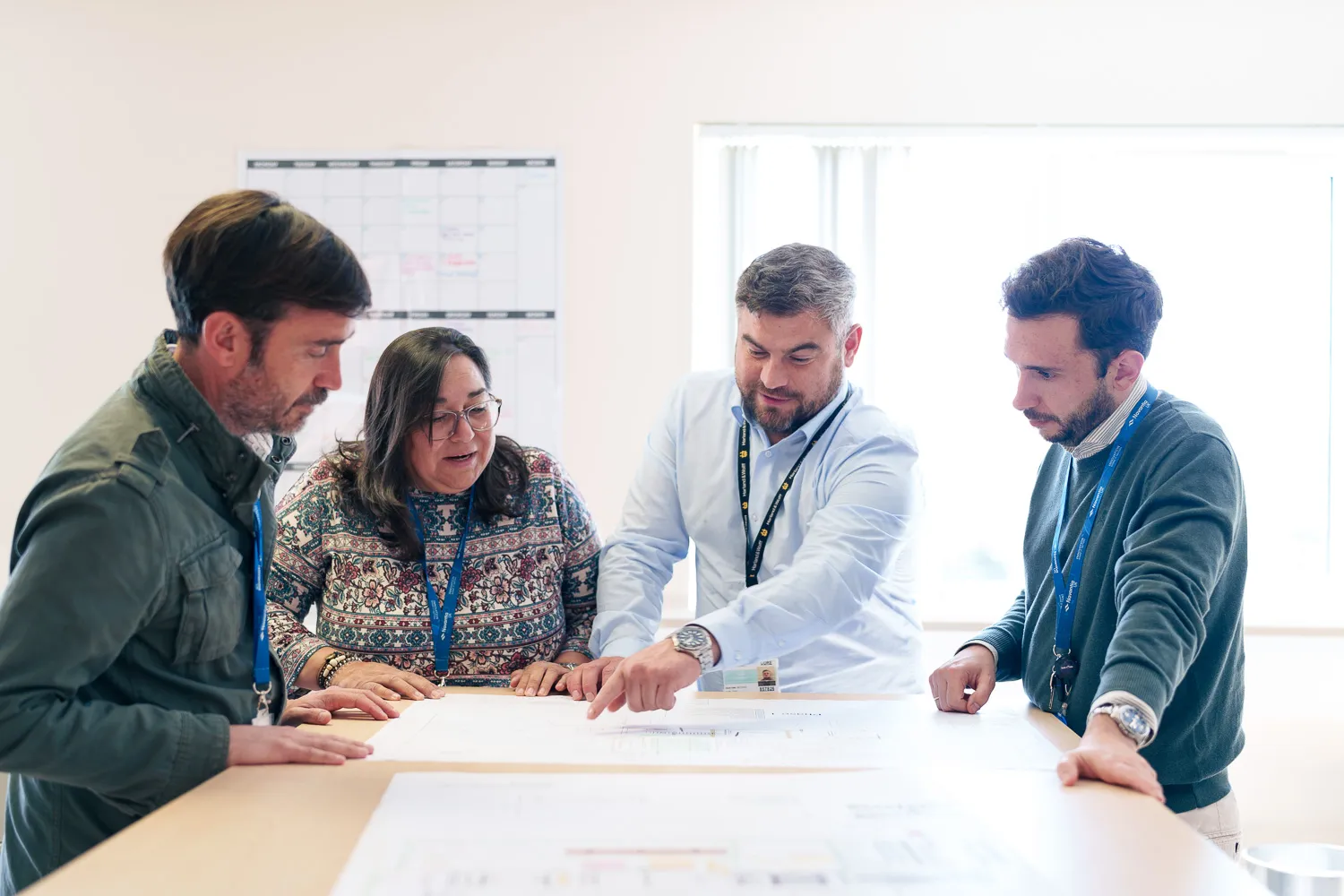 Navantia staff collaborating in a workspace, focused on their work and teamwork