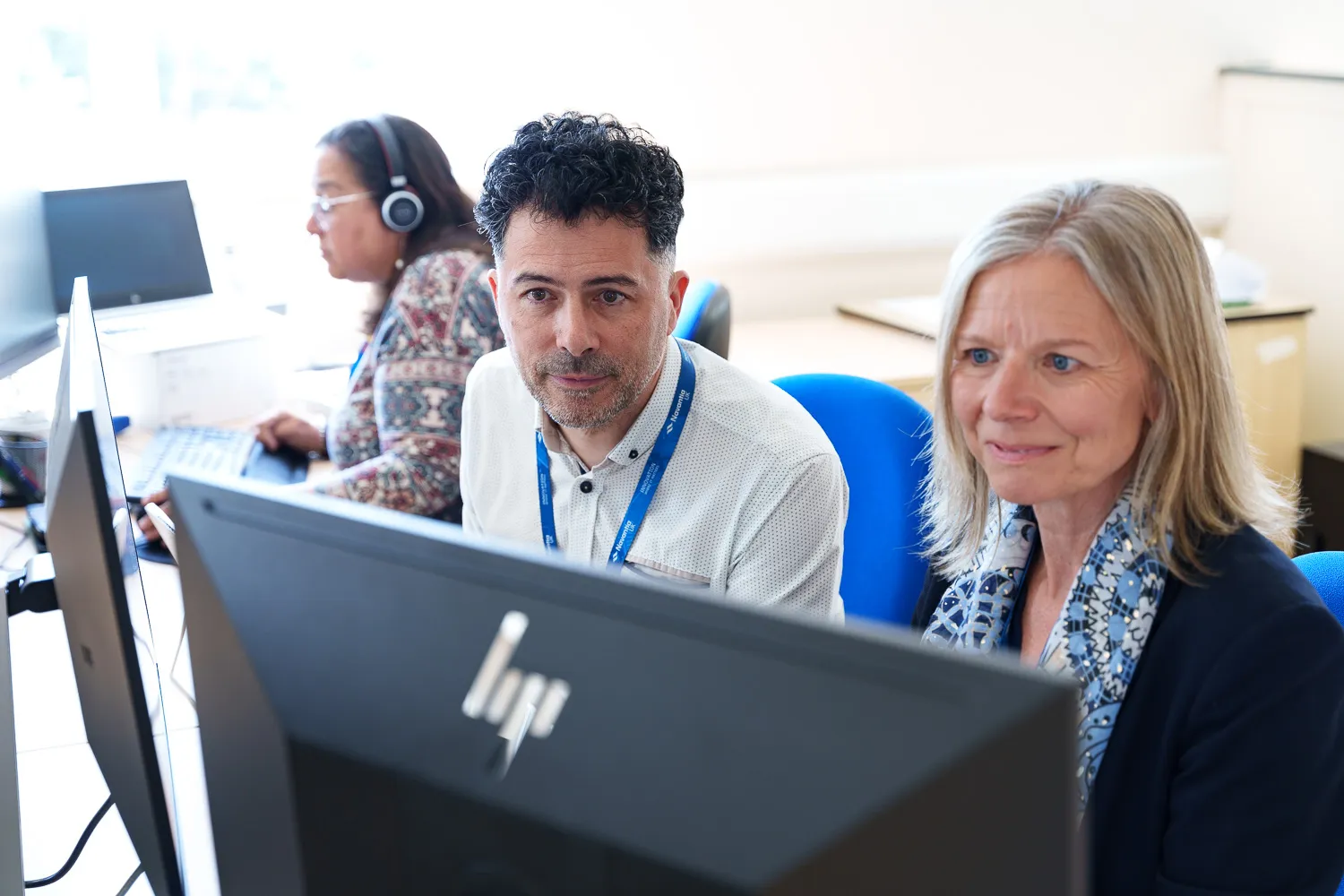 Navantia staff collaborating in a workspace, focused on their work and teamwork