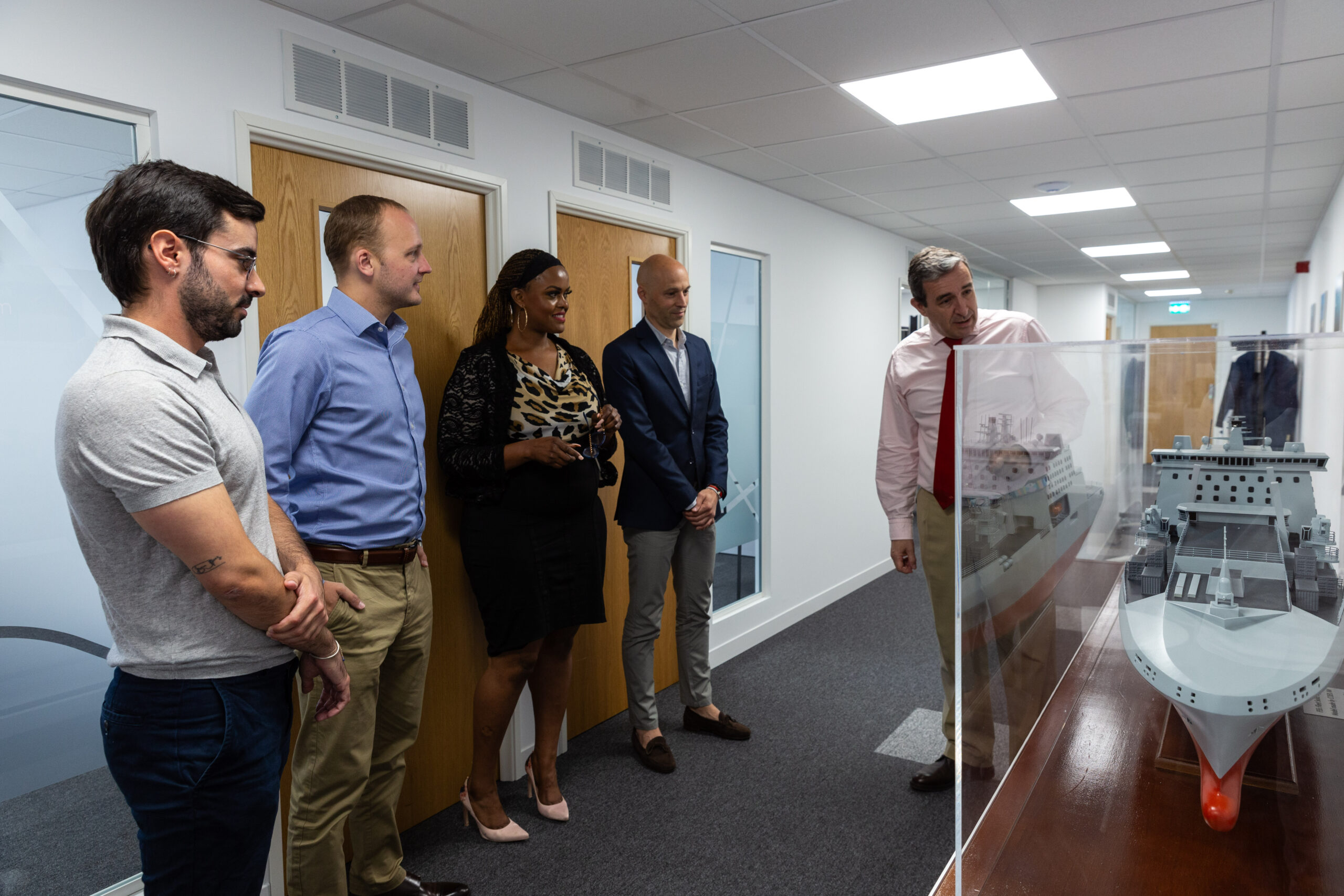 Team members conversing and sharing ideas while standing in the office